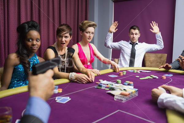 Hombre las manos en alto arma casino mano mesa Foto stock © wavebreak_media