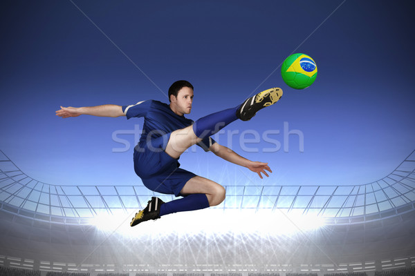 Stock photo: Football player in blue kicking