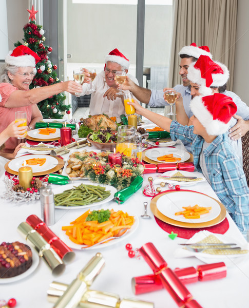 Family in santas hats toasting wine glasses at dining table Stock photo © wavebreak_media