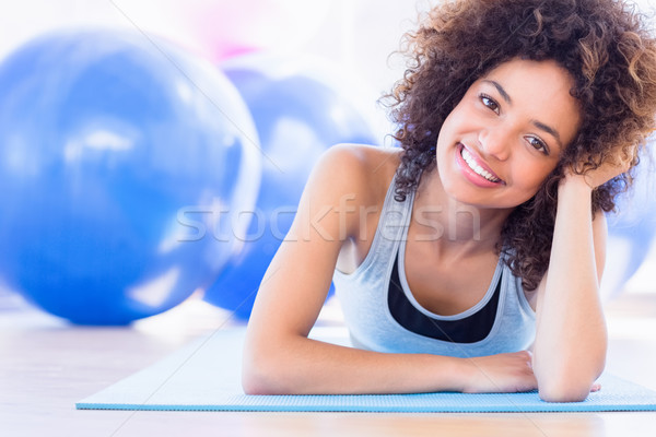 Fit woman lying on exercise mat in fitness studio Stock photo © wavebreak_media