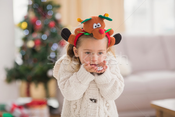 Festive little girl blowing over hands Stock photo © wavebreak_media