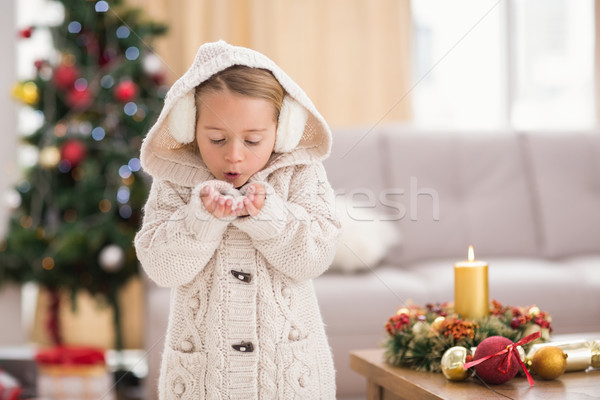 Festive little girl blowing over hands Stock photo © wavebreak_media