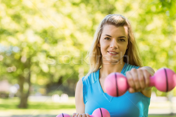 Fit blonde lifting dumbbells in the park Stock photo © wavebreak_media