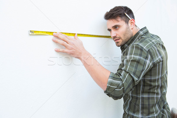 Marangoz beyaz duvar şerit metre yandan görünüş erkek Stok fotoğraf © wavebreak_media