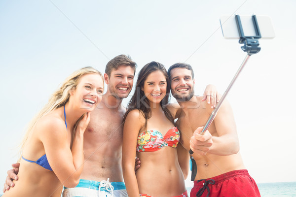 Stock photo: group of friends in swimsuits taking a selfie