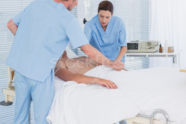 Medical team resuscitating a man with a defibrillator Stock photo © wavebreak_media