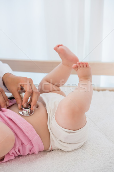 Beautiful cute baby girl with blonde doctor using stethoscope Stock photo © wavebreak_media