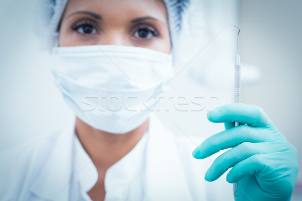 Female dentist in surgical mask holding hook Stock photo © wavebreak_media