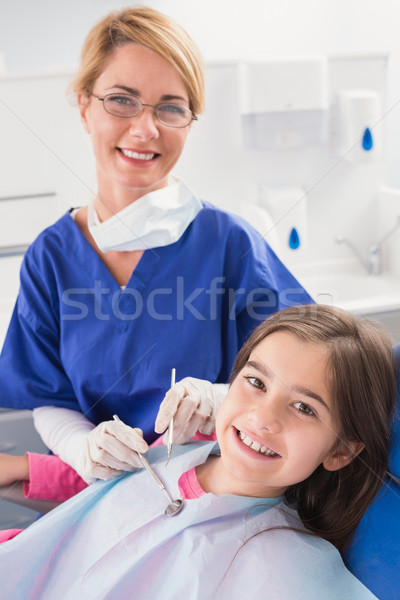 Smiling pediatric dentist with a happy young patient  Stock photo © wavebreak_media