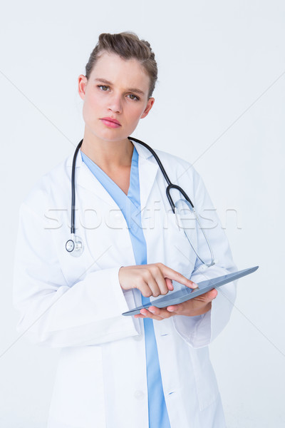 Unsure doctor pointing tablet pc Stock photo © wavebreak_media