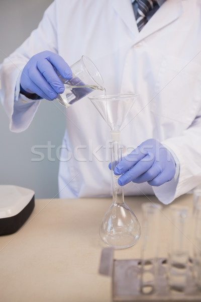 Scientist doing experimentations in flask  Stock photo © wavebreak_media