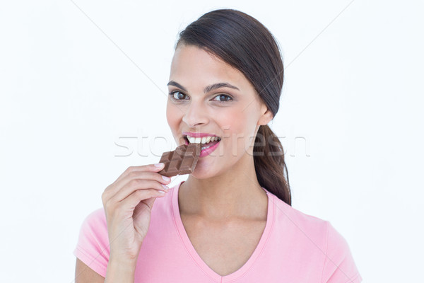 Gyönyörű nő eszik csokoládé fehér bár női Stock fotó © wavebreak_media