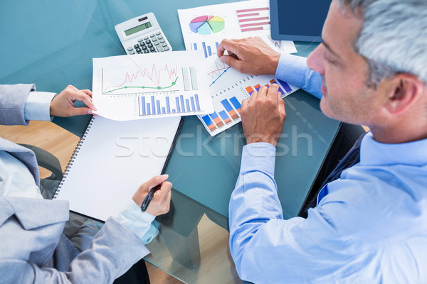 Business people looking at documents with graphics  Stock photo © wavebreak_media