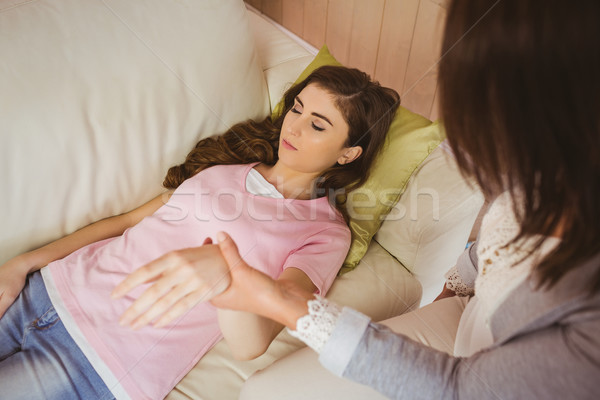 Hypnotherapist holding her patients wrist Stock photo © wavebreak_media