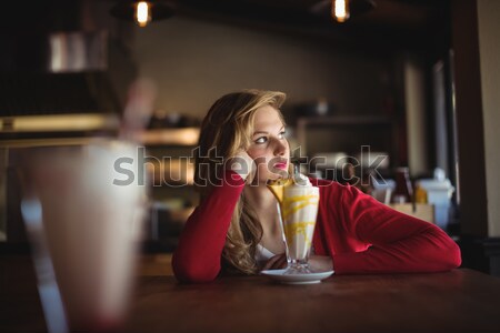 Portrait of beautiful woman having milkshake Stock photo © wavebreak_media