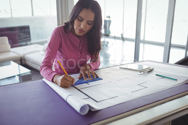 Female interior making diagrams on paper in office Stock photo © wavebreak_media