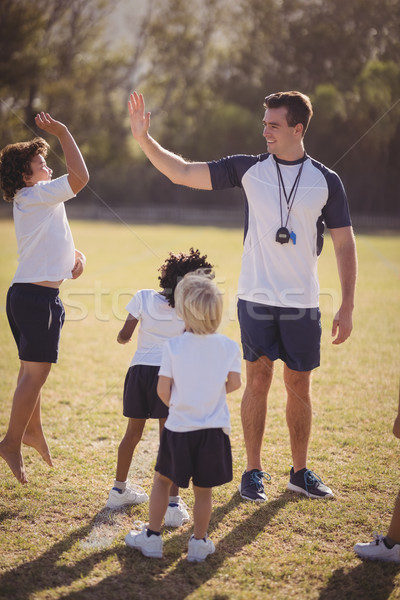 Coach écolière high five autre concurrence parc [[stock_photo]] © wavebreak_media