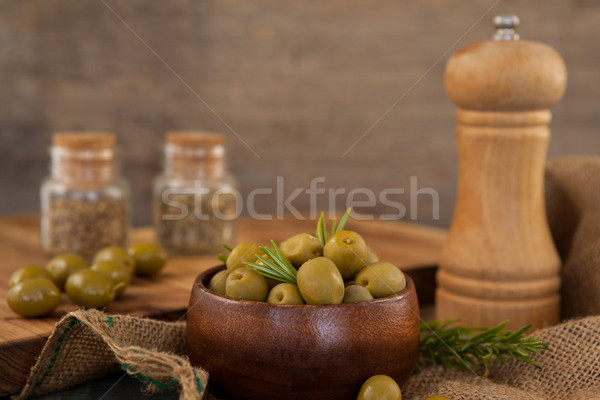 Olives and rosemary in bowl by pepper shaker Stock photo © wavebreak_media