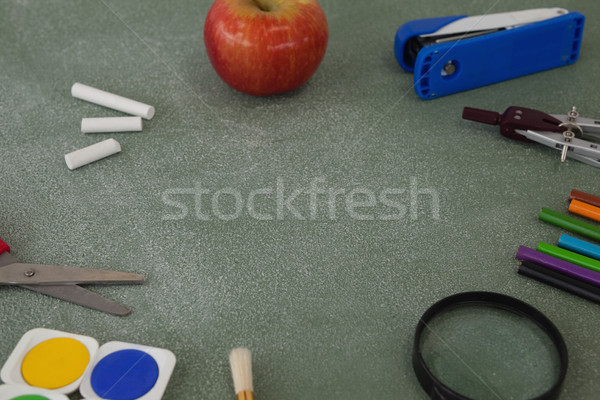 School supplies and apple arranged on chalkboard Stock photo © wavebreak_media