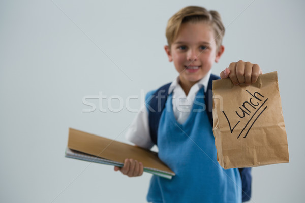 Glimlachend schooljongen boek lunch Stockfoto © wavebreak_media