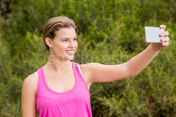 Pretty blonde athlete smiling and taking selfies Stock photo © wavebreak_media
