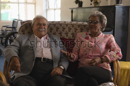 Happy couple looking at map while relaxing on canopy bed Stock photo © wavebreak_media