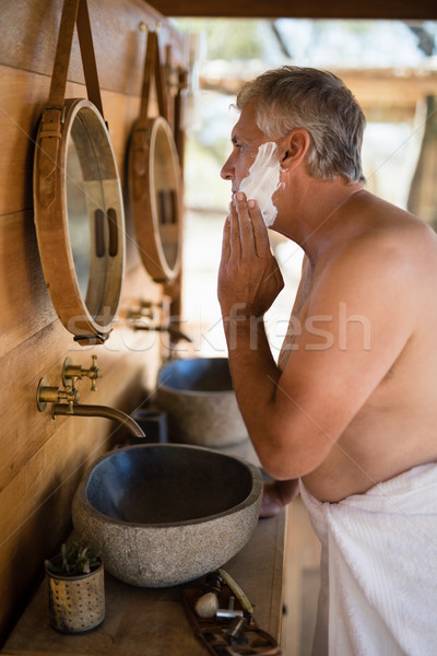 Man applying shaving cream on his face in cottage Stock photo © wavebreak_media