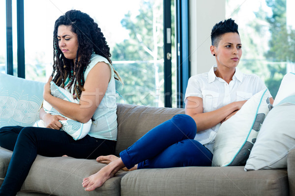 Unhappy lesbian couple sitting on sofa Stock photo © wavebreak_media