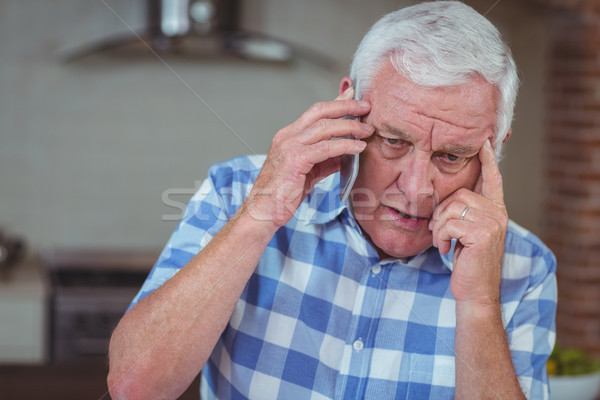 Worried senior man talking on mobile phone Stock photo © wavebreak_media