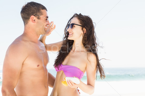 Girlfriend applying sun cream on boyfriend Stock photo © wavebreak_media