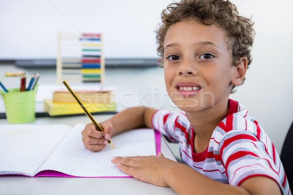 улыбаясь мальчика изучения столе классе портрет Сток-фото © wavebreak_media