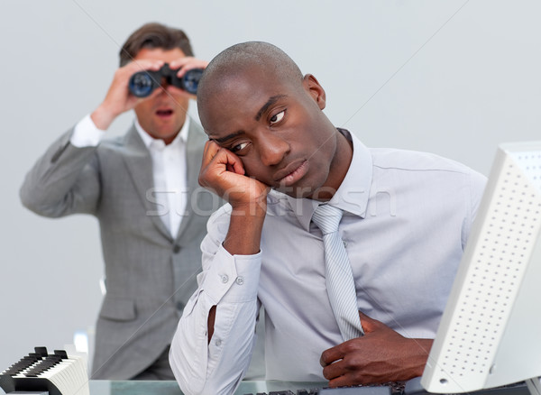 Businessman annoyed by a man looking through binoculars Stock photo © wavebreak_media