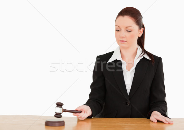 Young judge knocking a gavel against a white background Stock photo © wavebreak_media