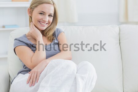 Woman lying on her sofa looking at the camera Stock photo © wavebreak_media