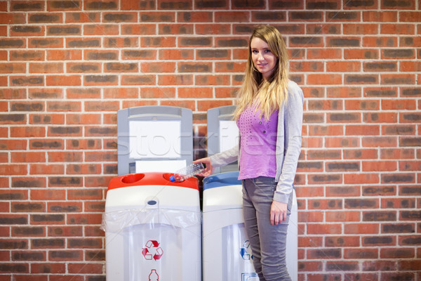 Cute woman recycling a plastic bottle Stock photo © wavebreak_media