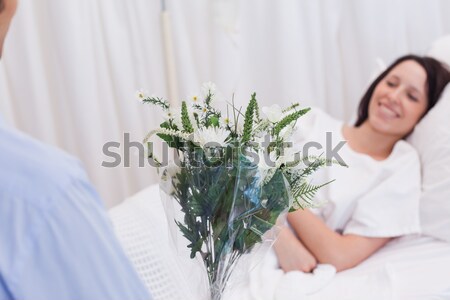 Young female patient getting flowers Stock photo © wavebreak_media