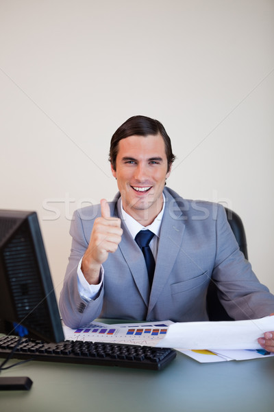 Smiling businessman approving statistics Stock photo © wavebreak_media