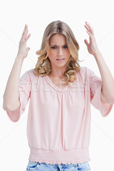 An annoyed woman has her both arms held up against a white background Stock photo © wavebreak_media