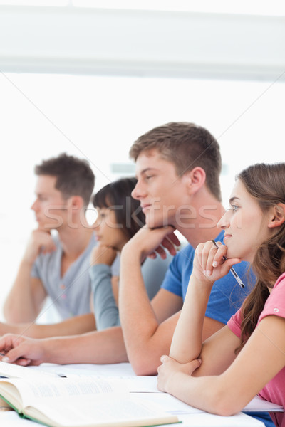 Stock photo: A group of students in class with one student looking a bit tired