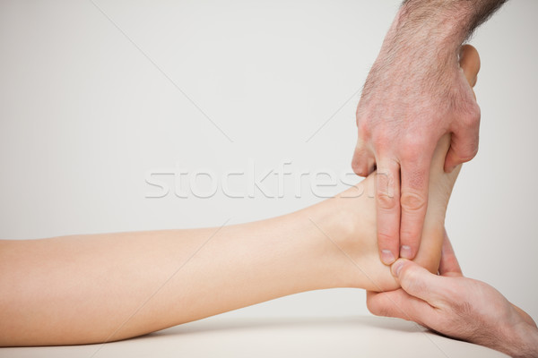 Chiropodist placing two fingers on a foot indoors Stock photo © wavebreak_media