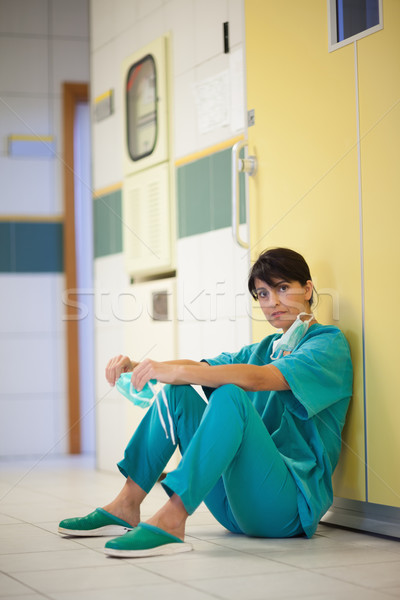 Surgeon sitting on the floor in a hallway Stock photo © wavebreak_media