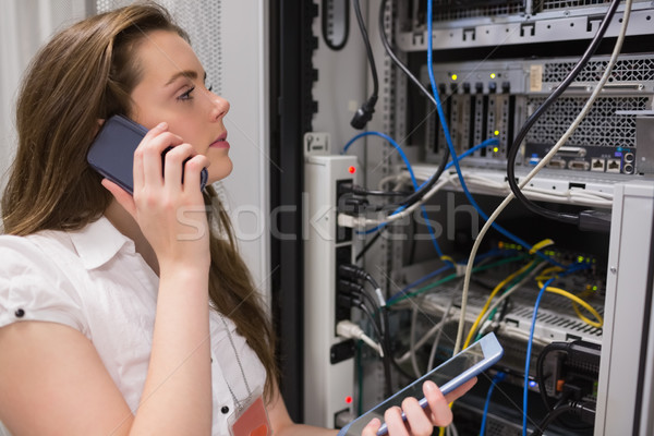 Woman working on servers with tablet pc on the phone in data center Stock photo © wavebreak_media