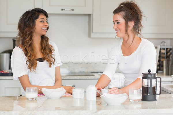 Two friends enjoying breakfast together in kitchen Stock photo © wavebreak_media