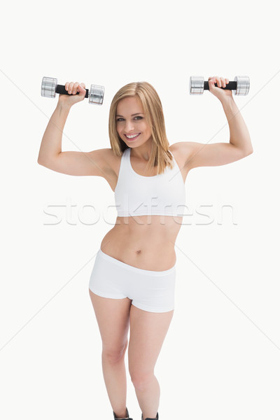 Stock photo: Portrait of young woman exercising with dumbbells