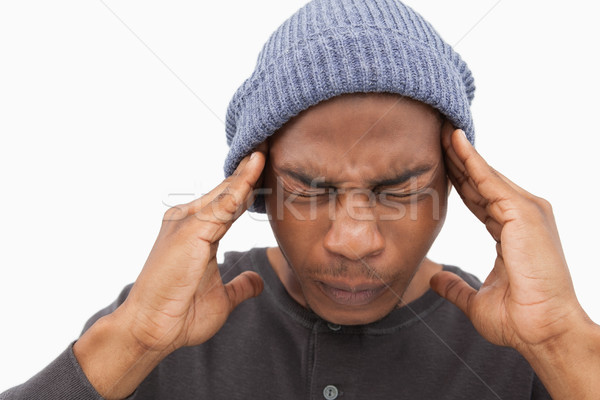 Man in beanie hat wincing with pain of headache Stock photo © wavebreak_media