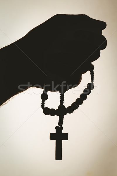 Hand holding rosary beads Stock photo © wavebreak_media