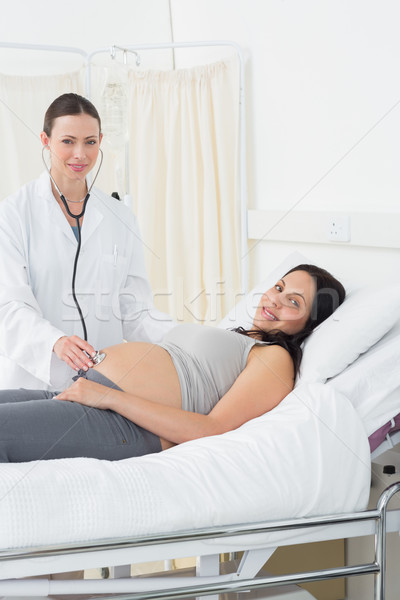 Confident doctor examining pregnant woman Stock photo © wavebreak_media