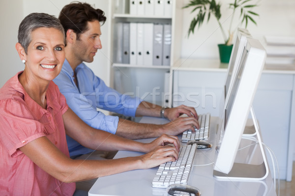 Casual business team working at desk using computers Stock photo © wavebreak_media