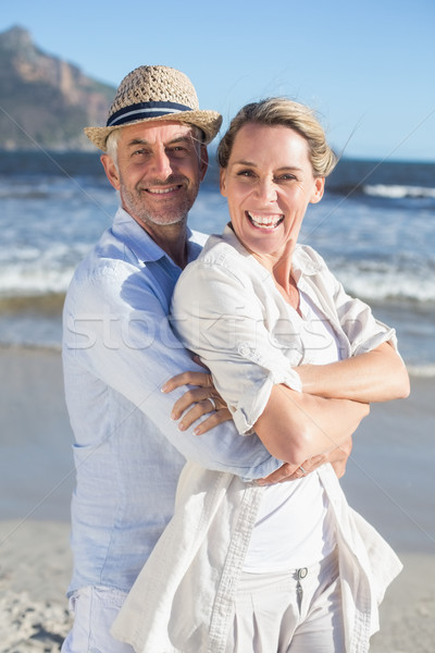 Happy couple standing on the beach together Stock photo © wavebreak_media