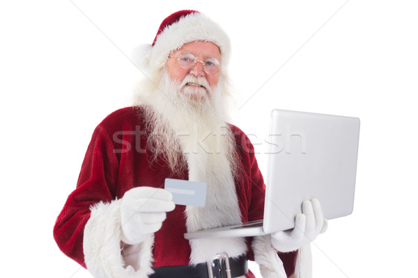Santa pays with credit card on a laptop Stock photo © wavebreak_media